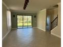 Spacious living room featuring tile floors and access to backyard at 8219 Caponata Blvd, Seminole, FL 33777