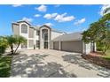 Two story house with a three car garage and palm trees at 4915 Augusta Ave, Oldsmar, FL 34677