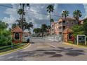 Gated entrance to community with palm trees and landscaping at 5000 Culbreath Key Way # 1-203, Tampa, FL 33611