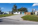 Exterior view showcasing the home's facade, driveway, lush lawn, and inviting curb appeal at 9322 88Th Way, Seminole, FL 33777