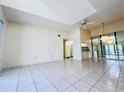 Bright living room with tile floors and view into kitchen at 1308 Pine Ridge E Cir # E3, Tarpon Springs, FL 34688