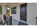 Modern front door with black finish and sidelights, welcoming porch at 1906 Cherry W St # 1, Tampa, FL 33607