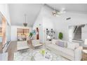 Bright living room with vaulted ceiling, modern furnishings, and an open floor plan at 1104 Kingfish Pl, Apollo Beach, FL 33572