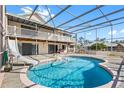 Backyard pool area with screened enclosure, balcony access, and a slide for Gathering fun at 1104 Kingfish Pl, Apollo Beach, FL 33572