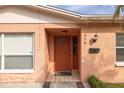 Orange house exterior with a brown door and welcoming entryway at 809 41St N Ave, St Petersburg, FL 33703