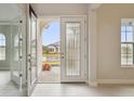 Elegant entryway with glass-paneled door and tile flooring at 12823 Daleridge Pl, Riverview, FL 33579