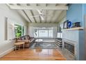 Bright living room featuring hardwood floors, fireplace, and large windows at 5101 W Platt St, Tampa, FL 33609