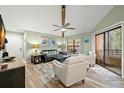 Spacious living room with vaulted ceilings and a cozy seating area at 104 Cypress Pond Rd, Palm Harbor, FL 34683