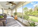 Relaxing screened-in porch with comfortable seating and beautiful views of the surrounding landscape at 2104 Hembury Pl # 33, Sun City Center, FL 33573