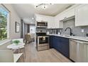 Modern kitchen with stainless steel appliances and two-toned navy and white shaker cabinets at 6338 8Th S Ave, Gulfport, FL 33707