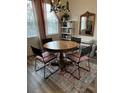 Round dining table with four chairs and decorative rug at 11712 Stonesmith Xing, Palmetto, FL 34221