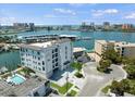 Aerial view of waterfront community, showcasing building and marina at 211 Dolphin Pt # 202, Clearwater Beach, FL 33767