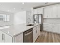 Kitchen featuring stainless appliances, white cabinetry and a kitchen island with a sink at 3584 Maple Bay Ln, Land O Lakes, FL 34638