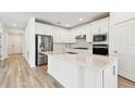 Modern kitchen with stainless steel appliances and an oversized kitchen island at 3584 Maple Bay Ln, Land O Lakes, FL 34638