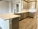 L-shaped kitchen island with white quartz countertop and gray cabinets at 12140 Warden Ave, Port Charlotte, FL 33981