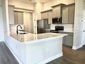 Modern kitchen with an island, stainless steel appliances, and white cabinets at 4570 Gillot Blvd, Port Charlotte, FL 33981