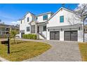 Modern farmhouse exterior, two-car garage, and manicured lawn at 4835 W San Jose St, Tampa, FL 33629