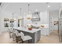 Modern kitchen with white cabinets, island seating, and high-end finishes at 4835 W San Jose St, Tampa, FL 33629