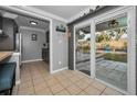 Kitchen with gray cabinets, wood counter, and sliding glass doors to backyard at 1619 Coppertree Dr, Tarpon Springs, FL 34689