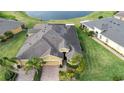 Property's roof and backyard, showcasing location near a lake at 649 Chipper Dr, Sun City Center, FL 33573