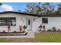Newly renovated mid-century home with white brick exterior and modern front door at 8816 Ashman Rd, Riverview, FL 33578