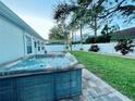 Modern hot tub on patio, surrounded by a landscaped backyard at 2353 Kilgore Dr, Largo, FL 33770