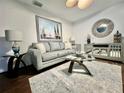 Bright living room featuring hardwood floors, comfy seating, and stylish decor at 2353 Kilgore Dr, Largo, FL 33770