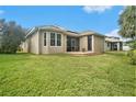 House exterior showcasing a backyard patio and lawn at 6232 French Creek Ct, Ellenton, FL 34222