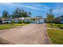 Gray exterior house with carport and well-maintained lawn at 6382 81St N Ave, Pinellas Park, FL 33781