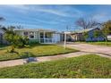 One-story house with gray siding, white trim, and a spacious front yard at 6382 81St N Ave, Pinellas Park, FL 33781