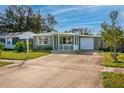 Single story home with gray exterior, white trim, and a 1-car garage at 6382 81St N Ave, Pinellas Park, FL 33781