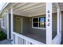 Covered porch with white railings and a green door at 6382 81St N Ave, Pinellas Park, FL 33781