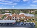 Aerial view showcasing condo community by a lake at 3840 Staysail Ln # 3840, Holiday, FL 34691