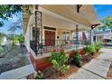 Charming yellow house with a red door and a wraparound porch at 2905 N 13Th St, Tampa, FL 33605