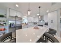 Modern kitchen with white cabinets, stainless steel appliances, and a large island at 2019 N Pebble Beach Blvd, Sun City Center, FL 33573