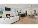 Open-concept living room boasts a fireplace, modern kitchen with stainless steel appliances, and a dining area at 1001 E New Orleans Ave, Tampa, FL 33603