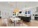 Bright living area featuring a dining table, kitchen island with seating, and a view of the front door at 1001 E New Orleans Ave, Tampa, FL 33603