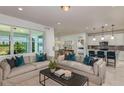 Open concept living space with sectional sofa and large windows at 4194 Feldspar Ln, Spring Hill, FL 34609