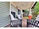 Inviting front porch with comfortable seating and a wooden deck at 1312 E Louise Ave, Tampa, FL 33603