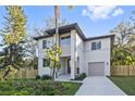 Modern two-story house with driveway and fenced backyard at 1919 E Hamilton Ave, Tampa, FL 33610