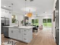 Spacious kitchen with island, stainless steel appliances, and white shaker cabinets at 1919 E Hamilton Ave, Tampa, FL 33610