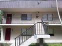 Two-story building with two units and a shared staircase at 11701 Raintree Village Blvd # C, Temple Terrace, FL 33617