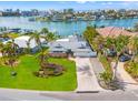 Waterfront property aerial view, showcasing the house and surrounding neighborhood at 10088 Paradise Blvd, Treasure Island, FL 33706