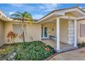 Front entrance with covered porch and landscaping at 43 Leeward Is, Clearwater Beach, FL 33767