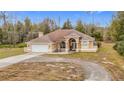 Tan one-story house with arched entryway and landscaping at 4367 Burns Rd, Brooksville, FL 34602