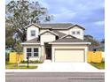 Two-story house with beige siding, gray roof, and a two-car garage at 3033 54Th N Ave, St Petersburg, FL 33714