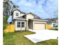 Two-story house with beige siding, gray roof, and a fenced backyard at 3033 54Th N Ave, St Petersburg, FL 33714