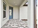 Front entrance with blue door and patterned tile flooring at 9461 Shorebird Ct, Parrish, FL 34219