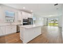 Modern kitchen with white cabinets, stainless steel appliances, and island at 9461 Shorebird Ct, Parrish, FL 34219