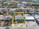 Aerial view showcasing property lines of single-story home with mature tropical landscaping and convenient location near local school at 422 86Th Ave, St Pete Beach, FL 33706